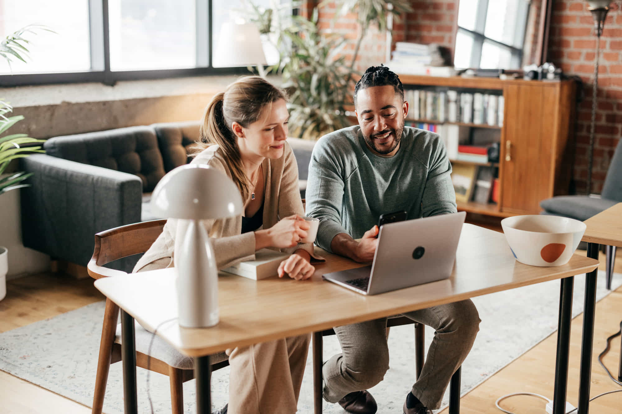 two people looking at a laptop